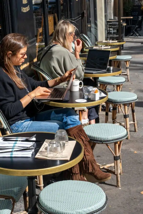 Fringe boots worn at a Parisian café September 2025